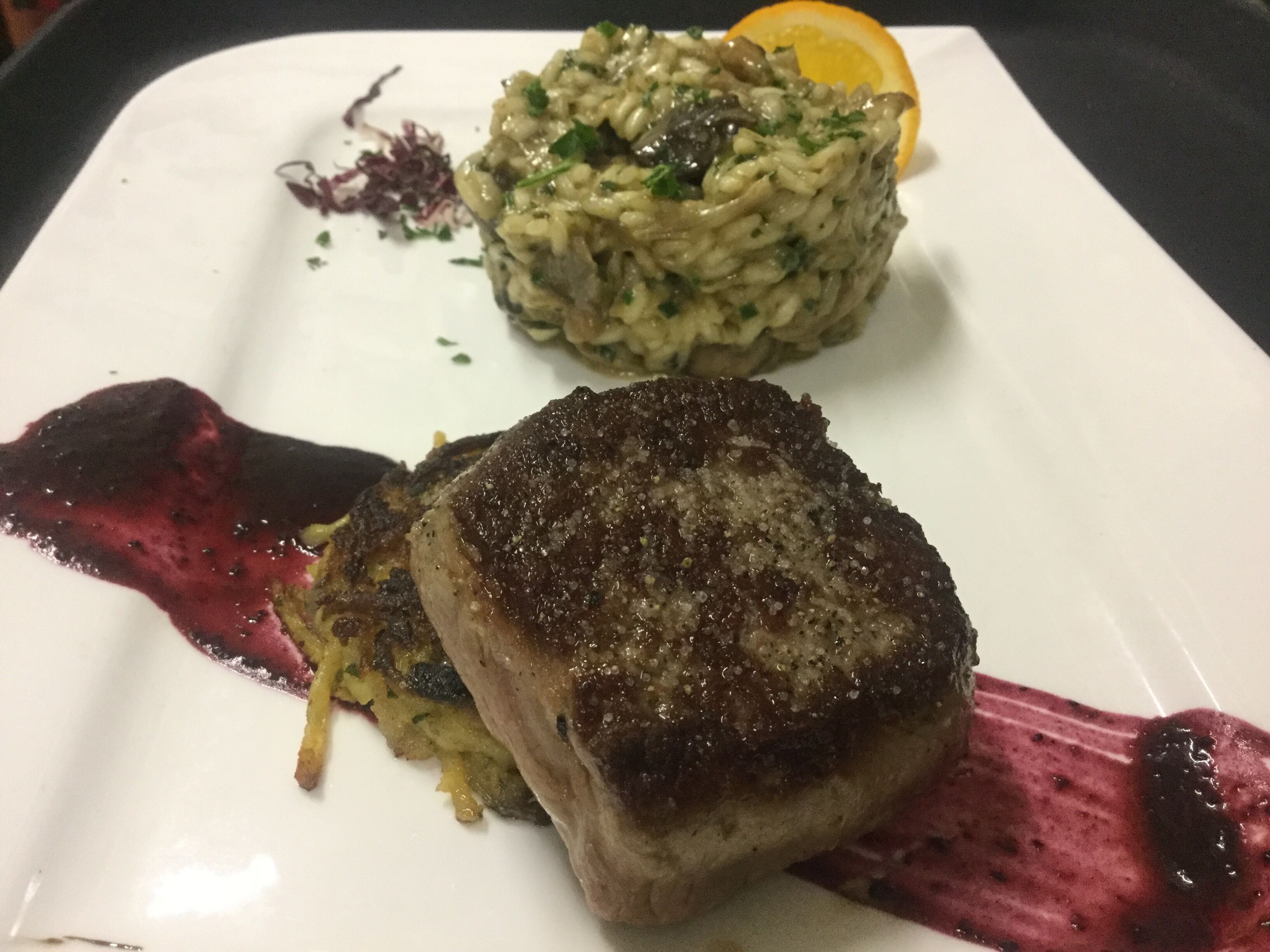 A plate with a steak and a side of rice.