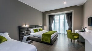 A modern hotel room with a large bed, bedside tables, a desk, and a chair. - Hotel Matilde - Lifestyle Hotel (Naples)