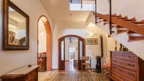 A spacious hallway with a wooden staircase, a large mirror, and a patterned floor. - Our sea view house offers space on 400 square meters for 2-10 people (Magomadas (OR))