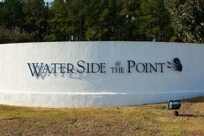 A large white wall with the text "Water Side at the Point" and a logo. - Waterside Resort (Roper)
