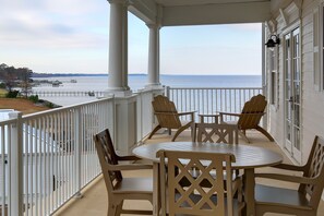 A covered outdoor seating area with a view of the water. - Waterside Resort (Roper)