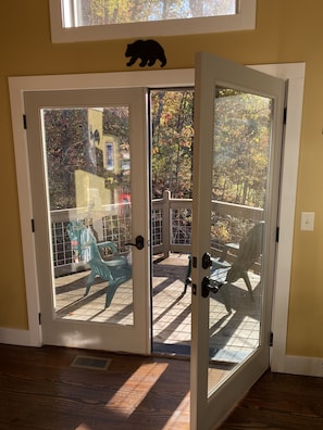 Enjoy the view from your deck with a sliding glass door leading out to a furnished outdoor space.