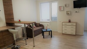 Cozy living space with a dining area, sofa, and television.
