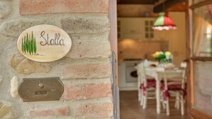 A rustic brick wall with a wooden plaque reading "Stalla" and a metal plate below it. - La Stalla, beautiful 2 bedrooms apartment in the Chianti region with pool & A/C (Tavarnelle Val di Pesa)