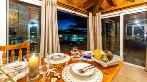 A dining table set for a meal with a candle, starfish, and a basket of fruits. - Il Nocciolo 12, Emma Villas (Cecina)