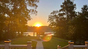 A pathway leading to a gazebo by a lake at sunset. - Waterfront Retreat in Toledo Bend (Many)