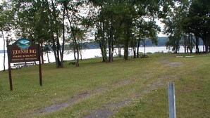 A park sign for Edinburg Park & Beach with a path leading to a lake. - Private Dock in Protected Cove (Edinburg)