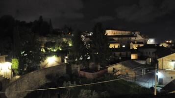 A historic building with a stone facade, a courtyard, and a bridge.