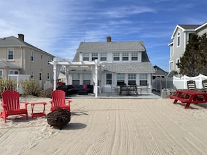 Relax on the covered patio with a grill and Adirondack seating.