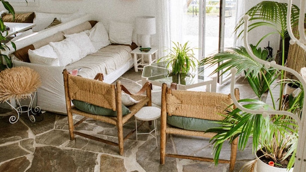 A spacious living room with a stone floor, white furniture, and large windows allowing natural light. - House center Guethary Maisons Dominos 1 (Guéthary)