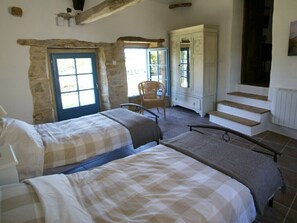 A bedroom with two beds, a chair, a wardrobe, and a staircase. - Period Farmhouse, sleeps 12, large 12m x 6m pool, barn, big garden, courtyard (Verfeil)