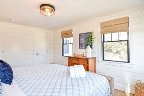 A bedroom with a bed, dresser, window with blinds, and a ceiling light fixture. - Gorgeous Home 2 Min Walk to Beach! (Harwich Port)