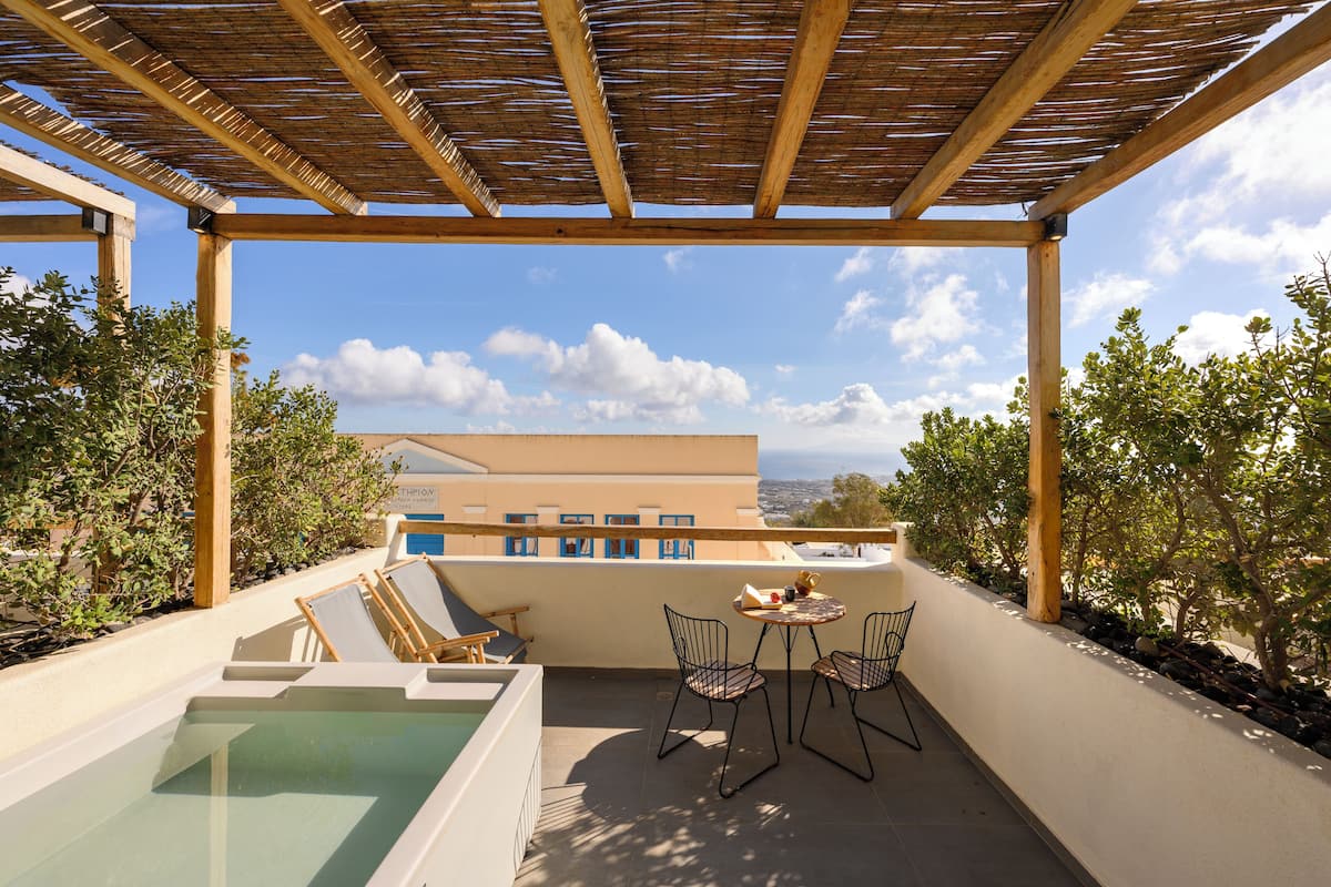 A rooftop terrace with a pool, two chairs, a table, and a pergola.