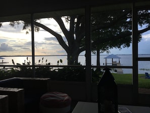 A view from a room with large windows overlooking a body of water, a dock, and a gazebo. - Lake June Zen Retreat (Lake Placid)