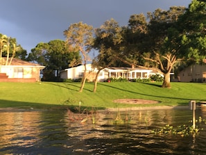 A residential area with a house, a lawn, and a pond. - Lake June Zen Retreat (Lake Placid)