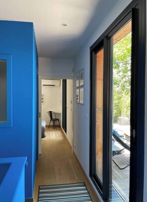 Enter a serene bedroom with a large sliding glass door and a comfortable bed.