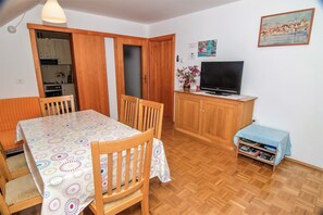 Cozy living space with a dining area, kitchenette, and TV.