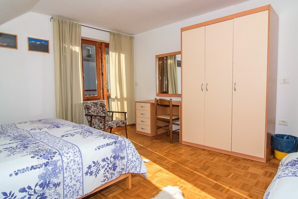 Cozy retreat with a comfortable bed, desk, and wardrobe.