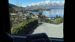 A view from a window overlooking a lake with snow-capped mountains in the background and a town in the foreground. - 7Manata - Amazing 270deg views! Golf & Ski 10bedrm/8bathrm + 4x seven-seat 4WD's (Fernhill)