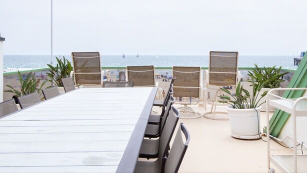A balcony with a view of the beach and ocean. - Seaside Home - Full home rental - Beachfront, Full Beach Front Home - 2002 W. Oceanfront (Newport Beach)