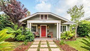 A house with a number 1929 on the front door, a covered porch with two chairs, and a stone pathway leading to the entrance. - Charming Home w/ Private, Enclosed Yard, Easily Accessible to All of SB! (Santa Barbara)