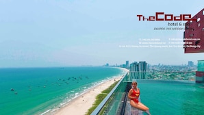 A hotel with a view of a beach and ocean. - The Code Hotel & Spa (Da Nang)