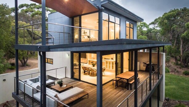 A modern two-story house with a deck, outdoor seating, and large windows. - Carpe Vino - Peaceful Bushland Luxury Between Coast and Town (Margaret River)