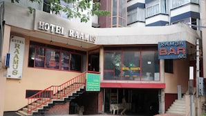 A building with a sign for Hotel Ramaus and a Ramba Bar. - Hotel Raamus (Coimbatore)