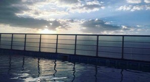 季節性室外游泳池,提供泳池遮陽傘和日光浴躺椅