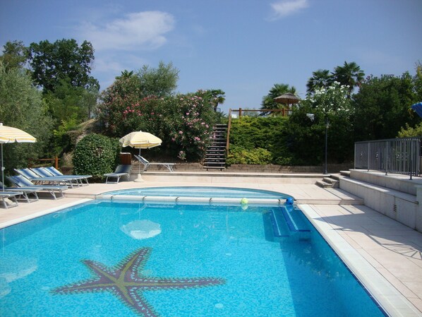 Outdoor pool, open 7:00 AM to 9:00 PM, pool umbrellas, pool loungers