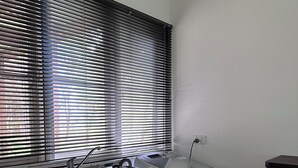 Una cocina compacta con un lavabo, un refrigerador pequeño y una cesta de mimbre.