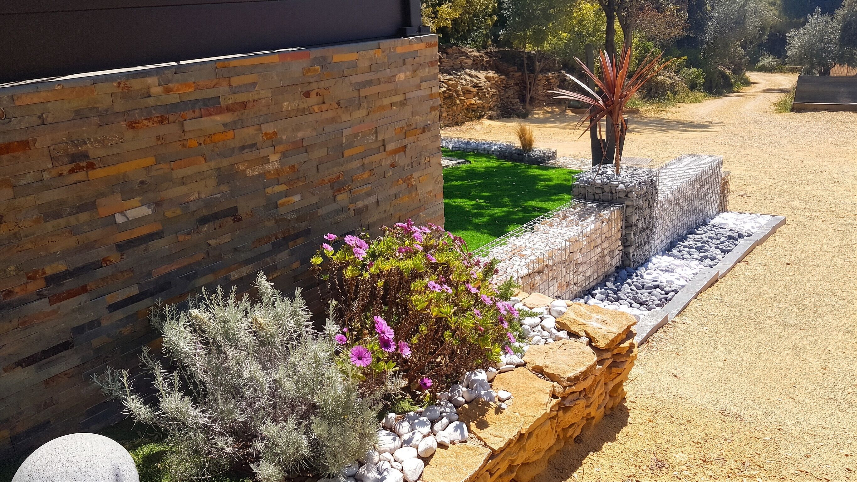 A landscaped garden with a brick wall, various plants, and a gravel path.