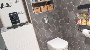 A bathroom with a toilet, a shower, and a sink area. - Homerez - House in Mornas (Mornas)