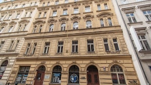 A multi-story building with ornate architectural details, including arched windows and decorative moldings. - Luxurious 5-bedroom apartment with wellness amenities (Prague)