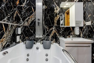 Habitación doble superior | Baño | Ducha y bañera combinadas y bañera de agua termal