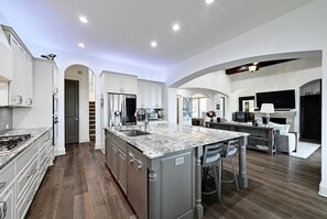 Fridge, stovetop, dishwasher, coffee/tea maker