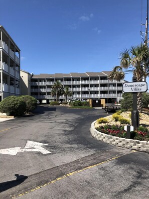 A multi-story building named 'Dunescape Villas' with a parking lot in front. - Dunescape with 3 ensuite full bathrooms. Private beach access chairs included! (Atlantic Beach)