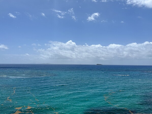 A view of the ocean with a distant island and a clear sky. - The Lighthouse, Unit 2C, Oyster Bay, St. Maarten (Upper Prince's Quarter)