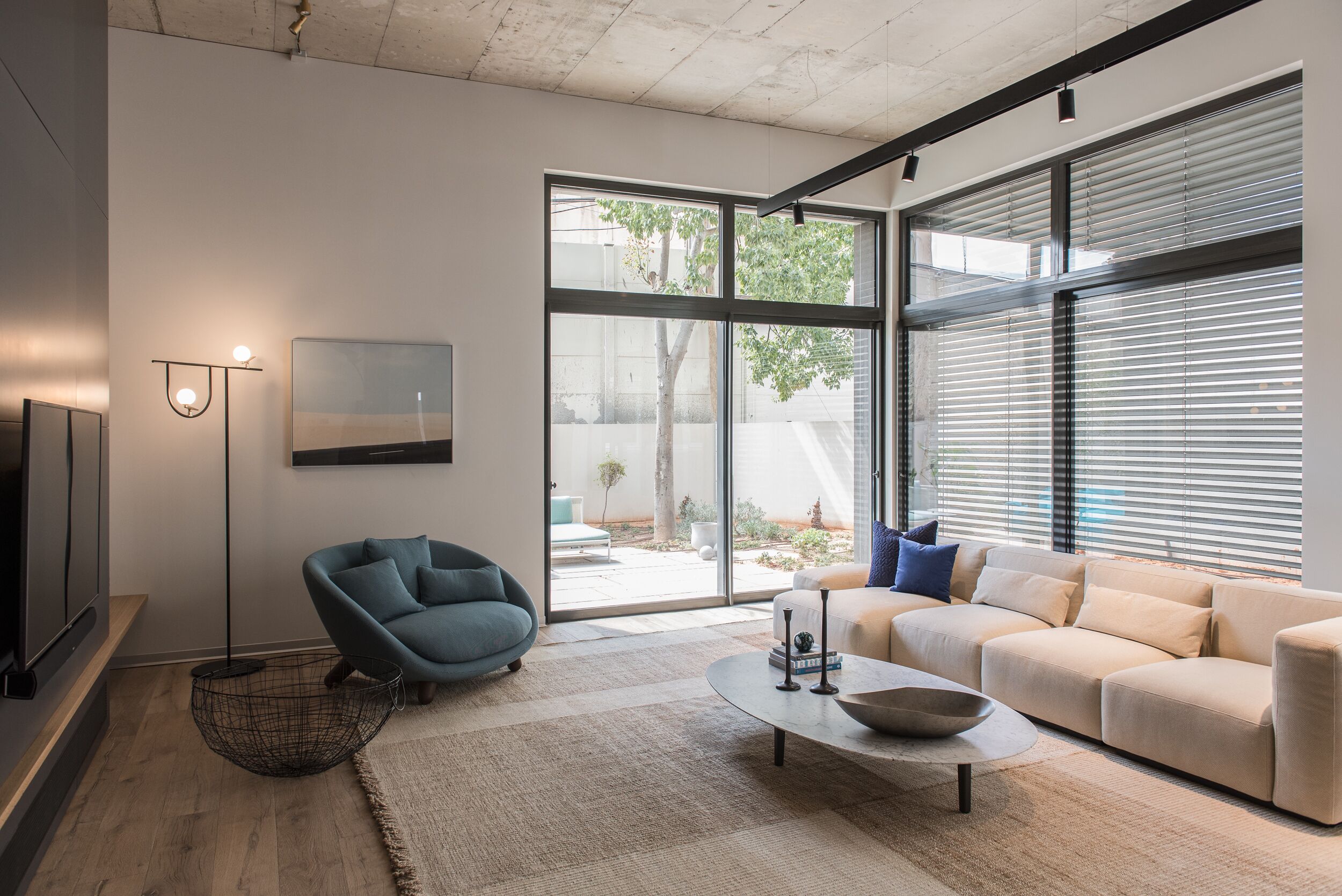 A modern living room with a sofa, coffee table, and floor lamp.