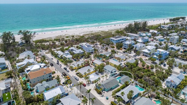 A coastal residential area with houses, a beach, and a clear view of the ocean. - Sea Spray 4: *Heated Pool *Pet-Friendly *Steps to beach *Shops, dining close (Anna Maria)
