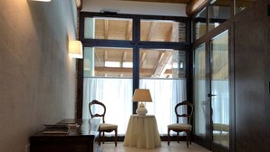 A room with a wooden desk, two chairs, a small table with a lamp, and large windows with curtains. - Relaxing historic villa,  cycle path to the city center, lake, Valpolicella  (Corno Alto)