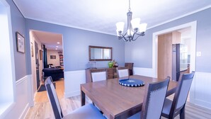 A dining room with a wooden table, chairs, and a chandelier. - .6 Walk to Carmel Midtown. Quiet and secure neighborhood. Plus massage chair! (Carmel)