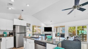 A modern kitchen with a central island, a built-in dishwasher, and a large refrigerator. - Gulf view, Steps to beach, heated pool, walk to restaurants (Destin)