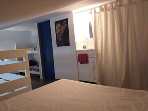 A room with bunk beds, a wardrobe, a mirror, and a curtain. - RESIDENCE IN SEASIDE (La londe les maures)
