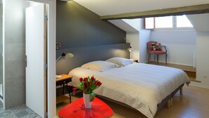 Une chambre à coucher avec un lit, un bureau, une chaise et une fenêtre.