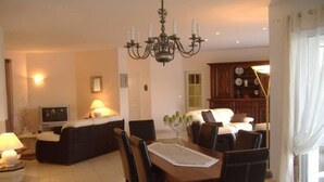 A well-lit living room with a dining area, a television, and a chandelier. - BETWEEN ARCACHON AND OCEAN, BIG HOUSE - LE TEMPLE (Le Temple)