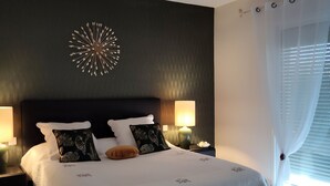 A well-lit bedroom with a large bed, two bedside tables with lamps, a decorative wall piece, and a window with curtains. - BETWEEN ARCACHON AND OCEAN, BIG HOUSE - LE TEMPLE (Le Temple)