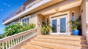 A building with a balcony, a staircase with a geometric pattern, and potted plants. - Mountaintop Villa with Spectacular Sunset View of Caribbean  (rincon)