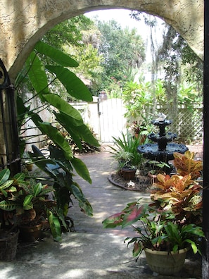 Tropical courtyard with fountain leading to your private entrance