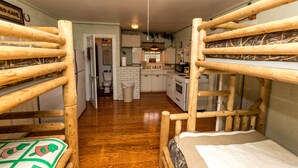 A bunk bed with a wooden frame and a mattress.